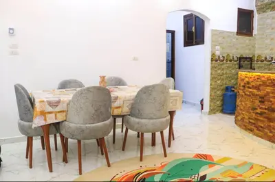 a dining room with a table and chairs at Shahd House in Luxor