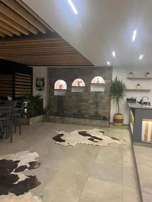 a room with a kitchen and a floor with a table at Sallam Lux Property in Hurghada