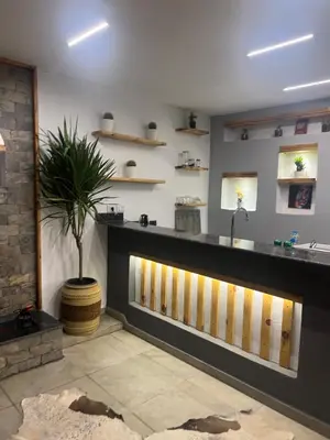 a lobby with a counter with a potted plant at Sallam Lux Property in Hurghada