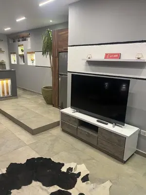 a living room with a large flat screen tv at Sallam Lux Property in Hurghada