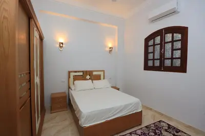 a small bedroom with a bed and a window at Ramsses Palace in Luxor