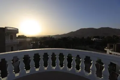 a view of the sunset from the balcony of a building at Ramsses Palace in Luxor