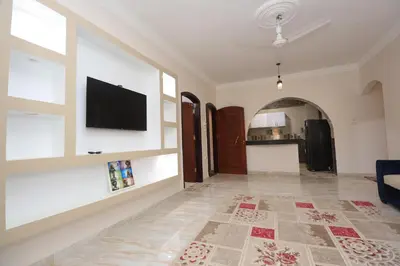 a living room with a flat screen tv on a wall at Ramsses Palace in Luxor