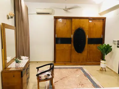 a living room with a wooden door and a chair at joy house in Luxor