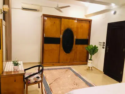 a room with a large wooden door with a potted plant at joy house in Luxor