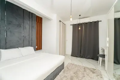 a bedroom with a white bed and a black wall at Hurghada apartment luxury 001 in Hurghada