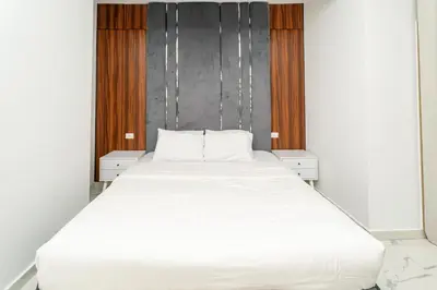 a large white bed in a room with windows at Hurghada apartment luxury 001 in Hurghada