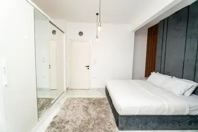 a white bedroom with a bed and a shower at Hurghada apartment luxury 001 in Hurghada