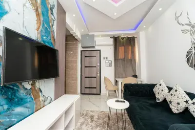a living room with a couch and a flat screen tv at Hurghada apartment luxury 001 in Hurghada