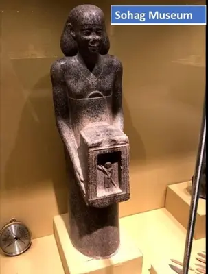 a statue of a woman holding a box in a museum at Abo Elwafa Hotel in Suwhaj