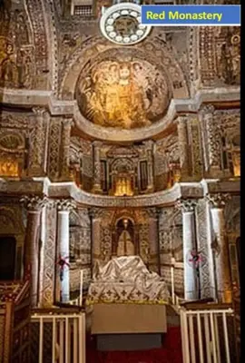 a church with a statue in the middle of it at Abo Elwafa Hotel in Suwhaj