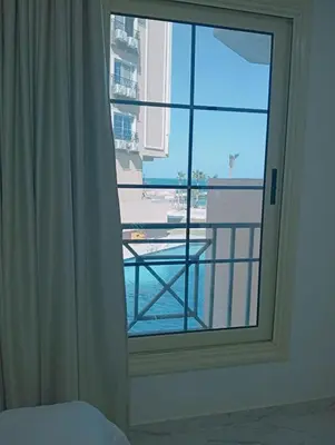 a bedroom window with a view of a balcony at جوليانا بيتش ريزورت in Hurghada