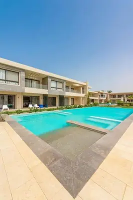 a large swimming pool in front of a building at El Gouna Luxury flat on the pool in El Gouna