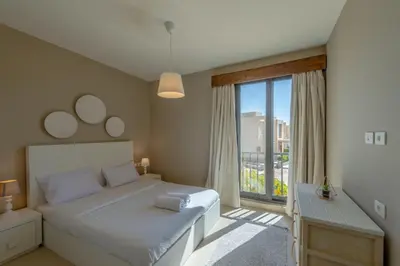 a bedroom with a bed and a large window at Ultimate Beachstyle Getaway Gouna 2BR Twinhouse. BBQ, Lagoon & Pool Access in Hurghada