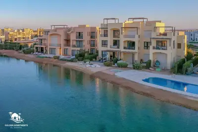a row of apartment buildings next to a river at Ultimate Beachstyle Getaway Gouna 2BR Twinhouse. BBQ, Lagoon & Pool Access in Hurghada
