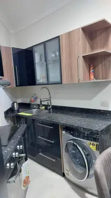 a kitchen with a washing machine and a sink at La Quinta Resort Hurghada in Hurghada