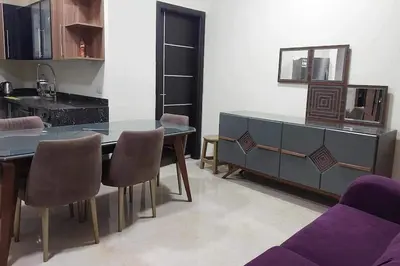 a living room with a dining table and a kitchen at La Quinta Resort Hurghada in Hurghada