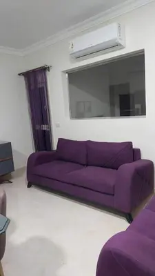 a purple couch in a living room with a mirror at La Quinta Resort Hurghada in Hurghada