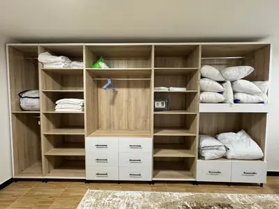 a closet with wooden shelves and white cabinets at Relaxation, fresh air, and a direct view of the Nile in Naj‘ al ‘Amrāb