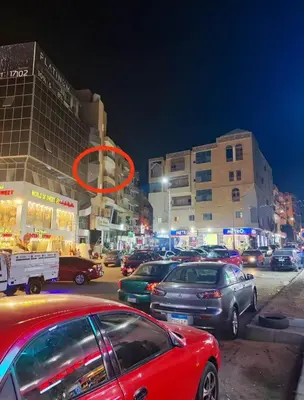a group of cars parked on a city street at night at Sheraton street METRO in Hurghada