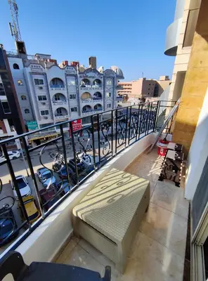 a bench sitting on the balcony of a building at Sheraton street METRO in Hurghada