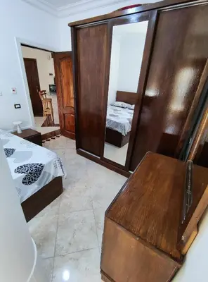 a bedroom with a mirror and a bed and a bed sidx sidx sidx at Sheraton street METRO in Hurghada