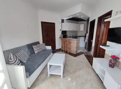 a living room with a couch and a kitchen at Sheraton street METRO in Hurghada