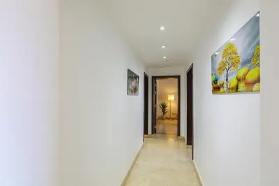 a hallway with white walls and a painting on the wall at Azzurra Sahl Haseesh in Hurghada