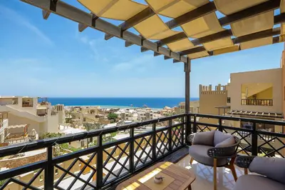 a balcony with chairs and a view of the ocean at Azzurra Sahl Haseesh in Hurghada