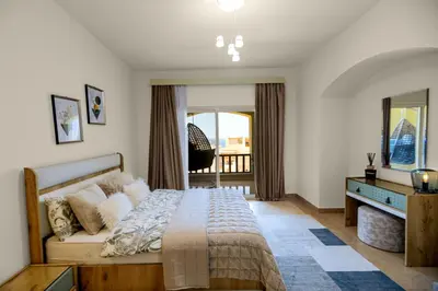 a bedroom with a large bed and a window at Azzurra Sahl Haseesh in Hurghada