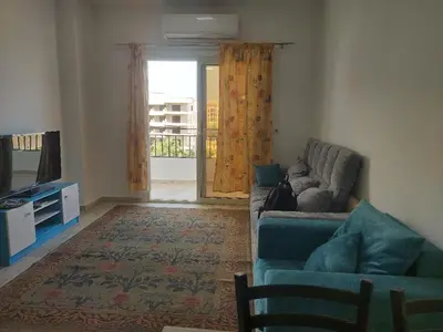a living room with a couch and a television at Makramia Compound in Hurghada