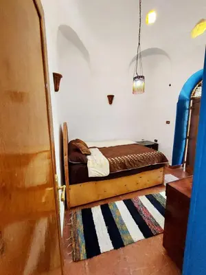 a bedroom with a bed in the corner of a room at Villa Cleopatra Luxor west bank in Luxor
