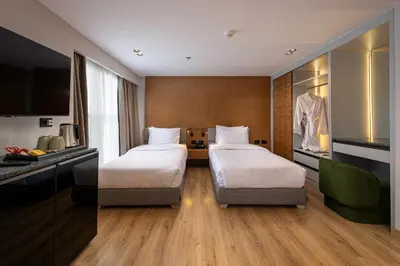 a hotel room with two beds and a tv at TIA Boutique Nile Cruise - Accommodation Only - Every Monday from Luxor for 04 & 07 Nights - Every Friday From Aswan for 03 & 07 Nights in Luxor