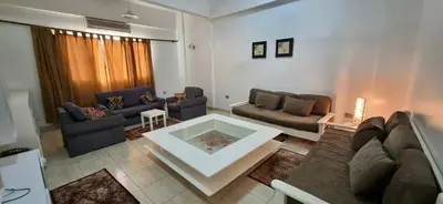 a living room with a couch and a table at Abo Hisham Nile Flat in Luxor