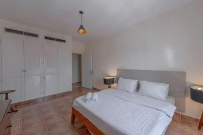 a bedroom with a large bed with white sheets and pillows at SeaView Penthouse with Roof in Marina El Gouna Egypt (Center) in Hurghada