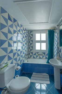 a blue bathroom with a toilet and a sink at SeaView Penthouse with Roof in Marina El Gouna Egypt (Center) in Hurghada
