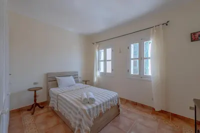 a bedroom with a bed and two shoes on it at SeaView Penthouse with Roof in Marina El Gouna Egypt (Center) in Hurghada