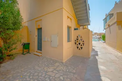 a building with a green chair on the side of it at SeaView Penthouse with Roof in Marina El Gouna Egypt (Center) in Hurghada