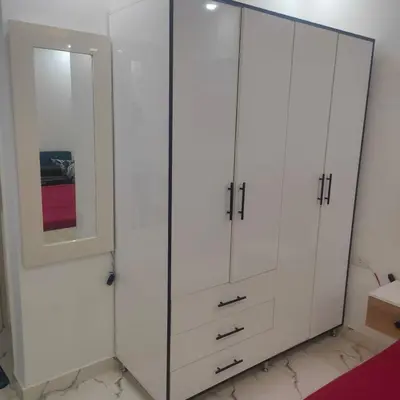 a white closet with a mirror and white cabinets at Hurghada Palma Resort Studio in Hurghada
