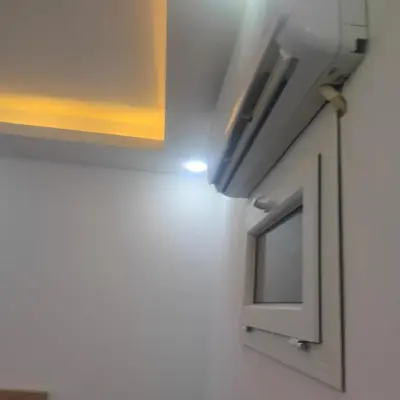 a kitchen with a cabinet and a tv on the wall at Hurghada Palma Resort Studio in Hurghada