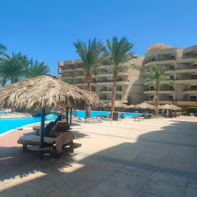 a resort with palm trees and a swimming pool at Hurghada Palma Resort Studio in Hurghada