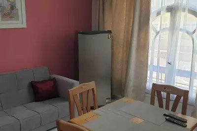 a living room with a couch and a table and chairs at Villa 2 apartment 4 village veiw infront of Palma de Meritee in Hurghada