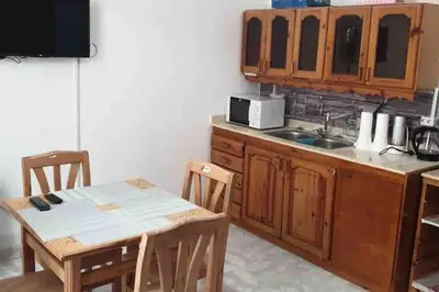 a kitchen with a table and a sink and a microwave at Villa 2 apartment 4 village veiw infront of Palma de Meritee in Hurghada