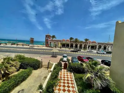 a view of a building with cars parked in a parking lot at Villa 2 apartament 3 sea view infront of Palma de Meritee in Hurghada
