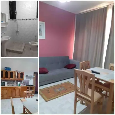 a living room with a blue couch and a table at Villa 2 apartament 3 sea view infront of Palma de Meritee in Hurghada