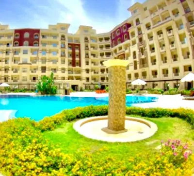 a resort with a large pool and a large building at Studio Pool view with balcony Florenza Hurghada in Hurghada