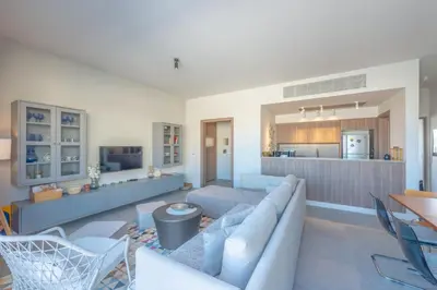 a living room with a couch and a kitchen at Boutique 2BR in Fanadir Marina - El Gouna. Lagoons & Red Sea in Hurghada