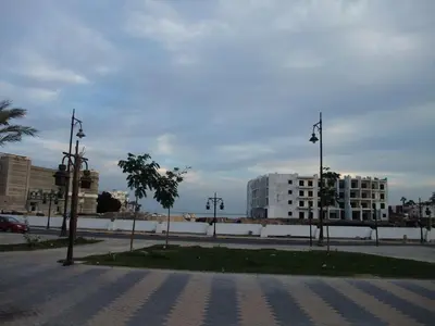 an empty street in a city with buildings at AlDau heights Maher in Hurghada