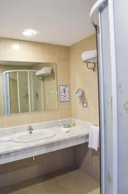 a bathroom with a sink and a mirror at Viva Blue Resort and Diving Sharm El Naga (Adults Only) in Hurghada