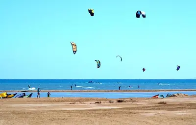 a group of people flying kites on the beach at Pool view studio with terrace in Hurghada
